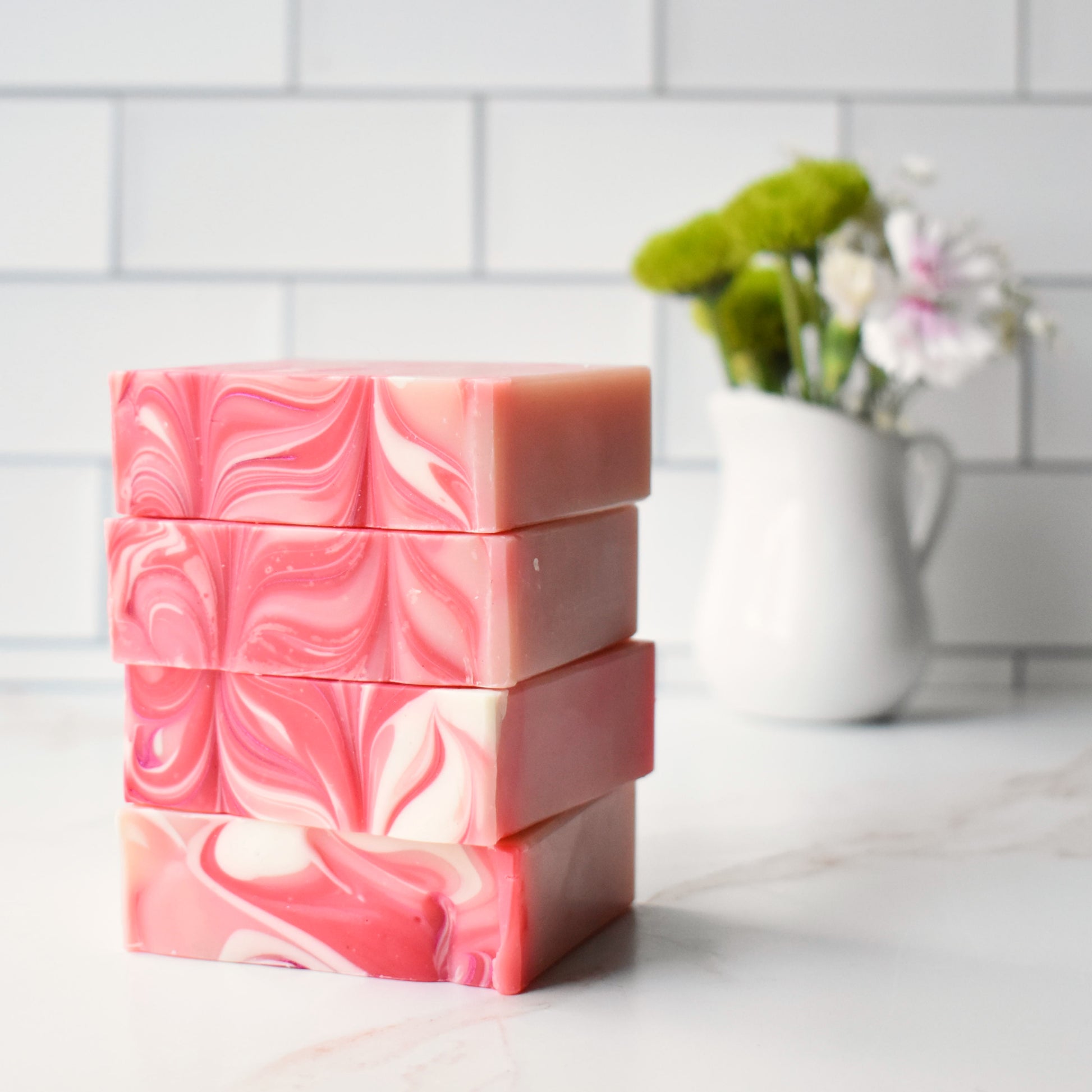 a stack of pink and white soap bars on a counter