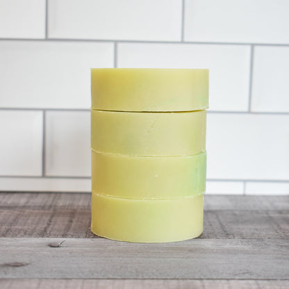 Stack of 4 green round solid shampoo
