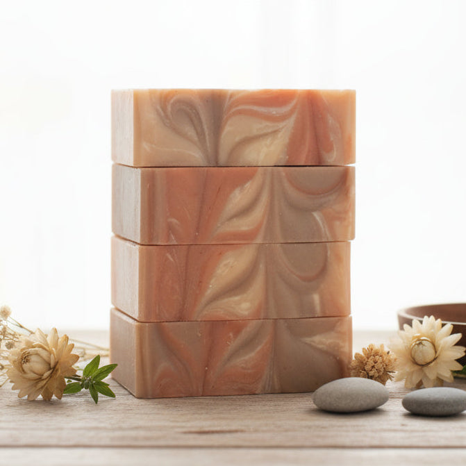 Stack of wooden containers with a bowl and flowers on a light surface