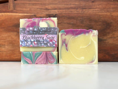 Blackberry sage soap shown in three different views: with label, top and whole bar
