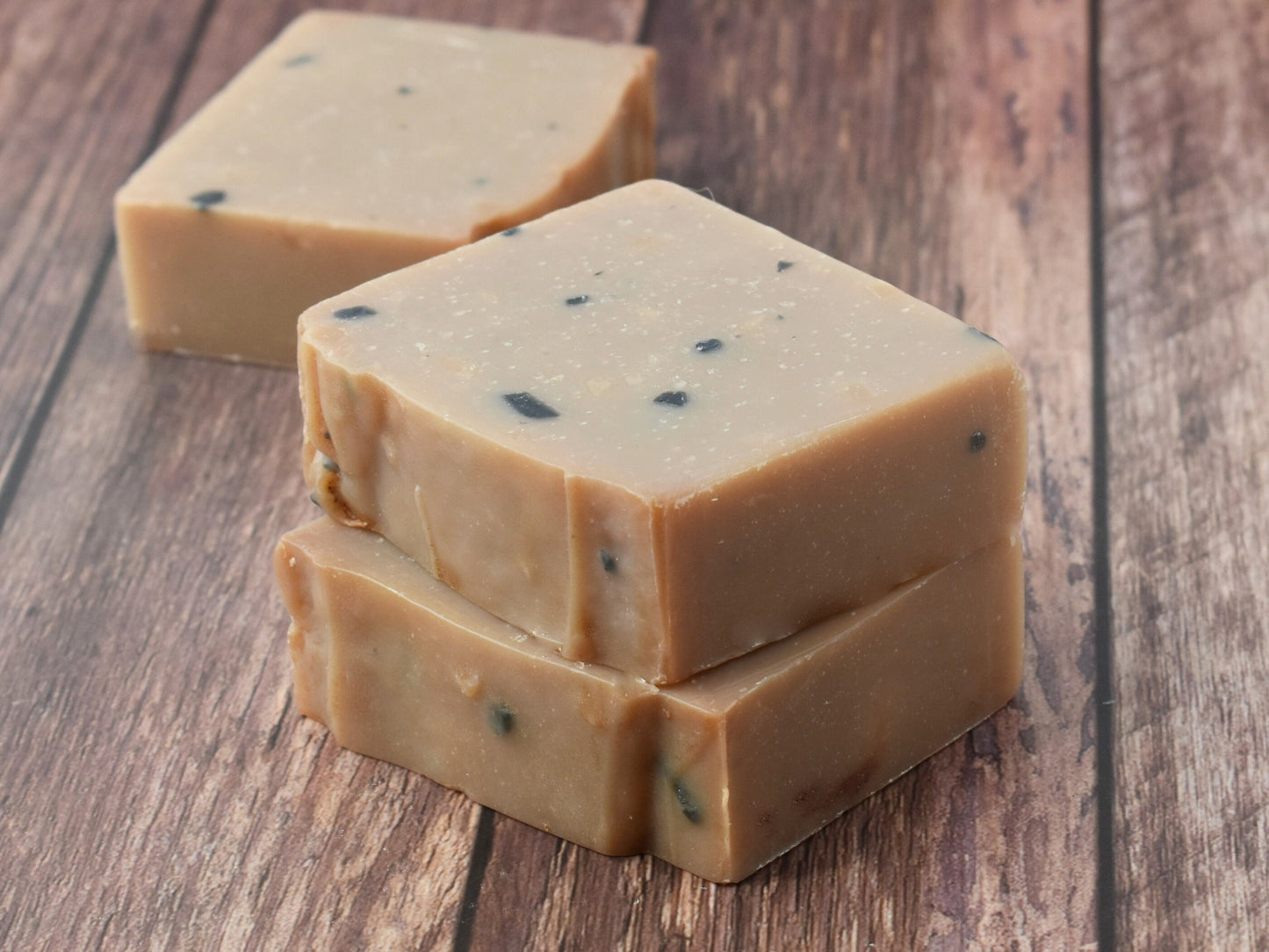 Leather Artisan Soap stacked and one soap on table behind