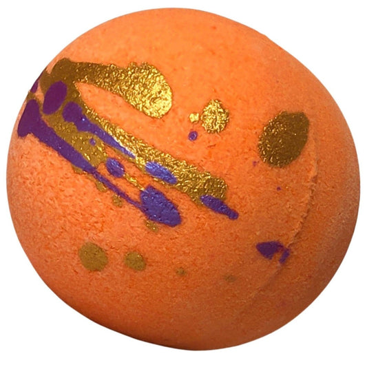 Deep orange round bath bomb with dark purple and gold “splashes” of color.