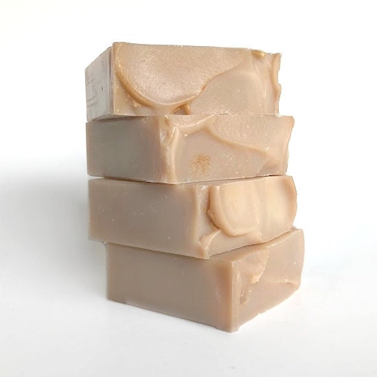 Handmade Egyptian Goddess soap collection, featuring four tan bars fanned out to display their intricate textures, set against a white background.
